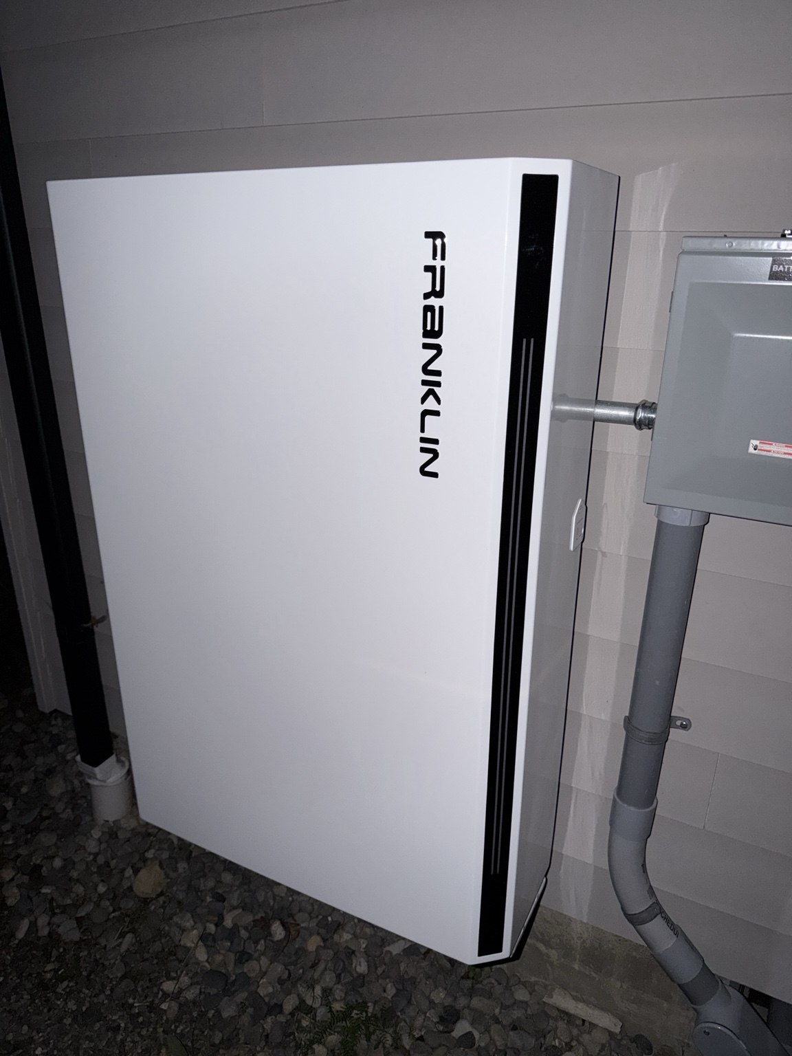 The FranklinWH aPower outside the house, beside the utility disconnect. About 27 kWh of LFP, the home’s backup partition, the policy engine’s most-managed asset.
