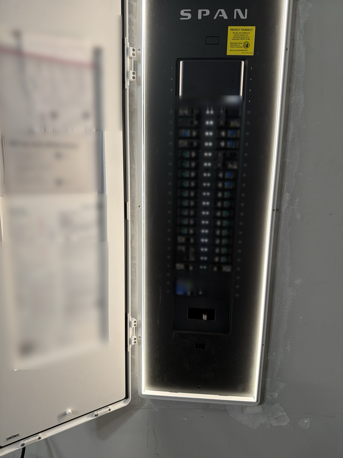The SPAN smart panel, door open: every breaker individually metered, every circuit individually controllable. The hardware is the means; the per-circuit metering is what makes the fusion view possible.